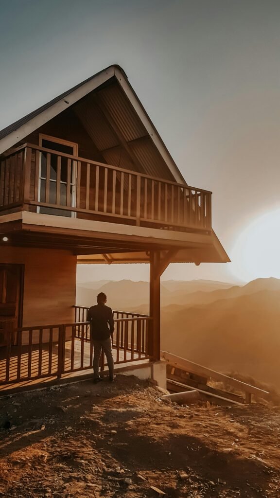Silhouette of a person on a balcony with a stunning sunset over Panamanian hills.